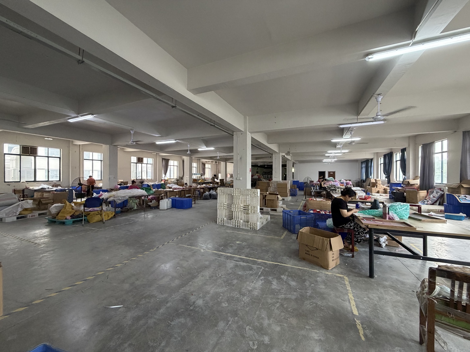 Staff working at assembly and packing tables