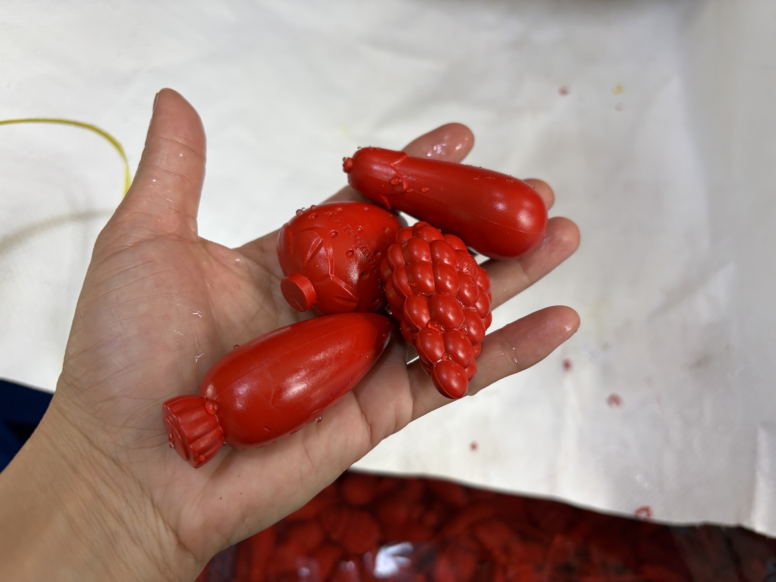 Close view of newly molded red fruit-shaped crayons
