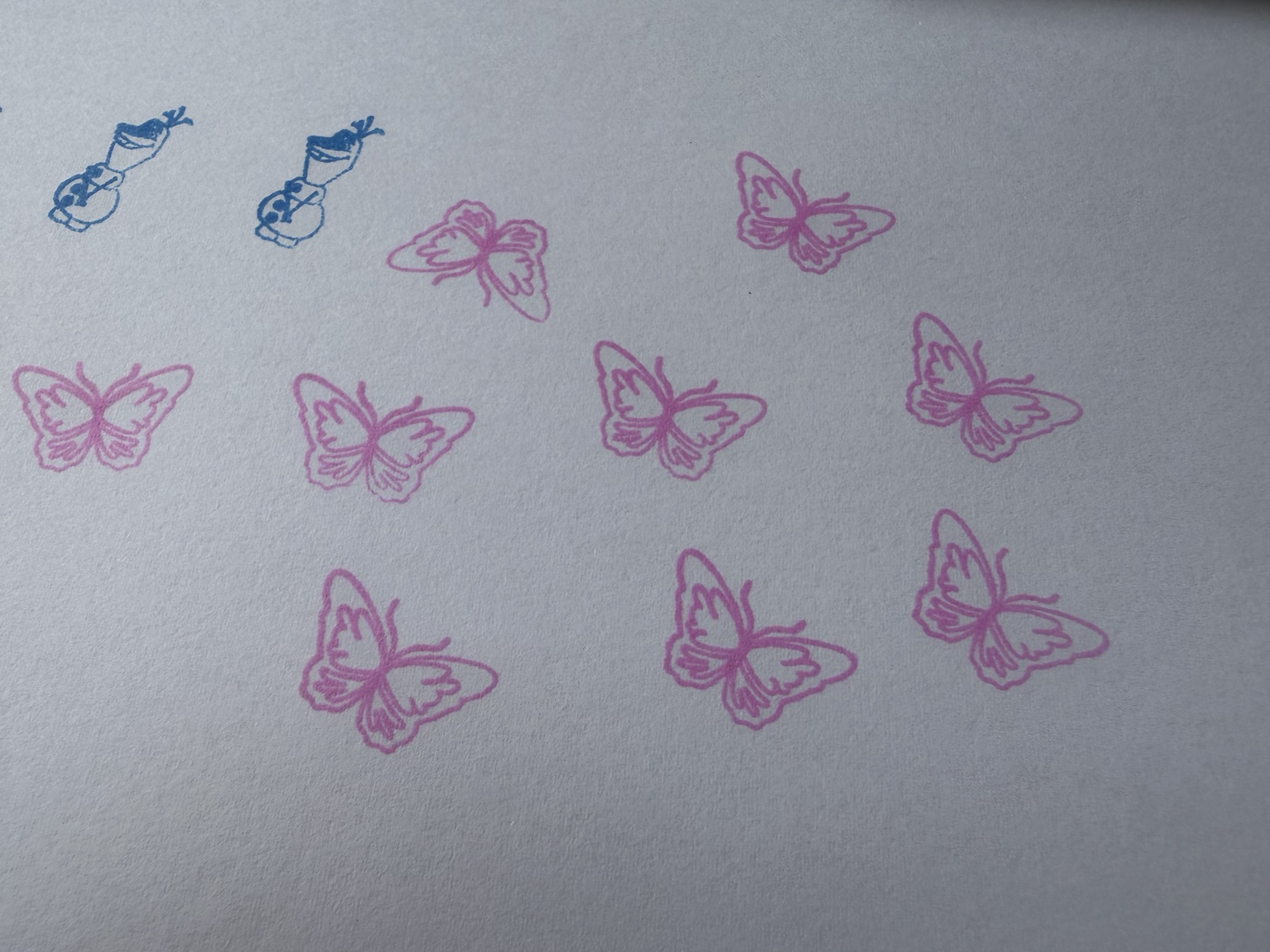 Blue and pink stamp impressions on paper