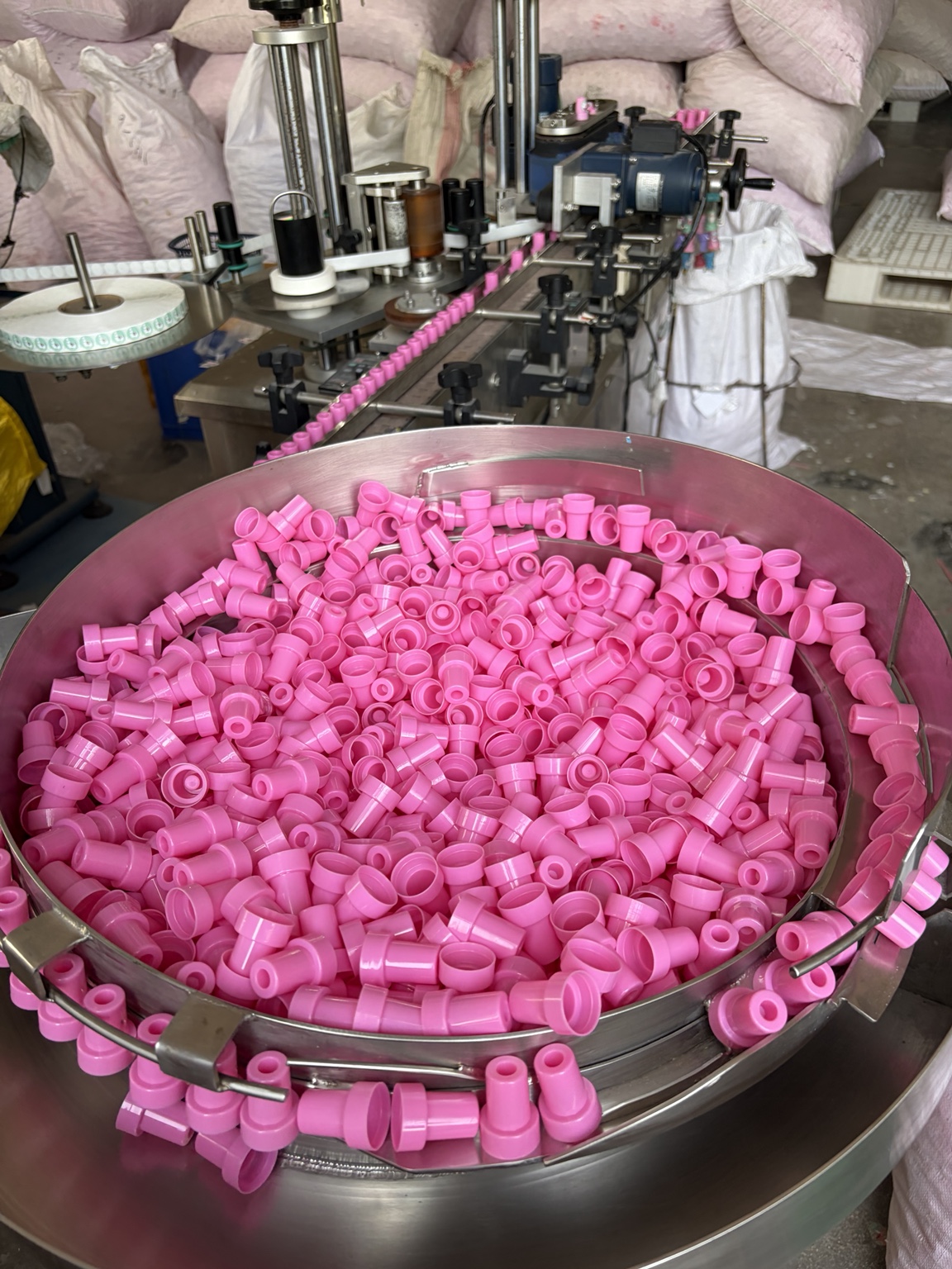 Pink stamp components in the labeling machine feeder